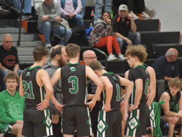 Coach Treadway with team before tip-off.