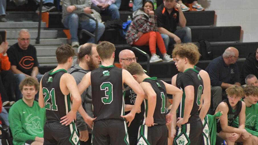 Coach Treadway with team before tip-off.